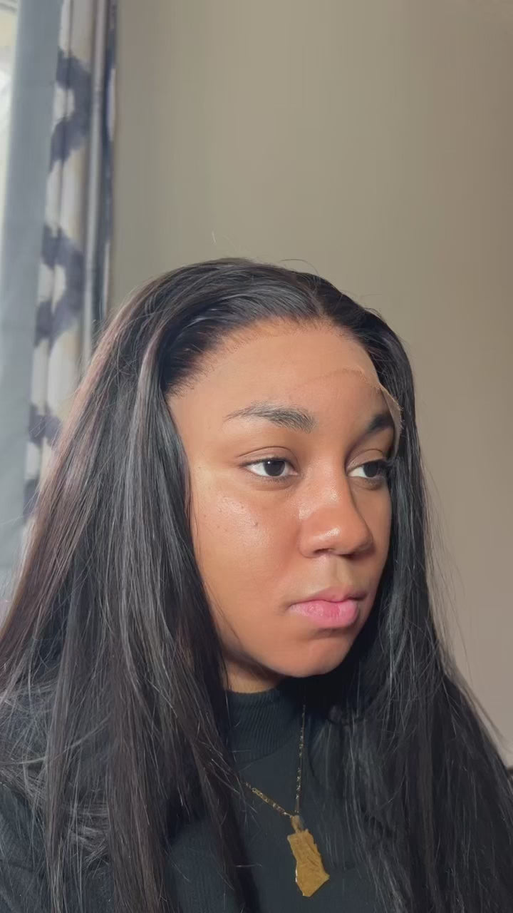A close-up of a raw Indian hair wig with glueless HD lace and raw Indian hair. The wig is styled in a sleek, straight style and the lace is transparent.