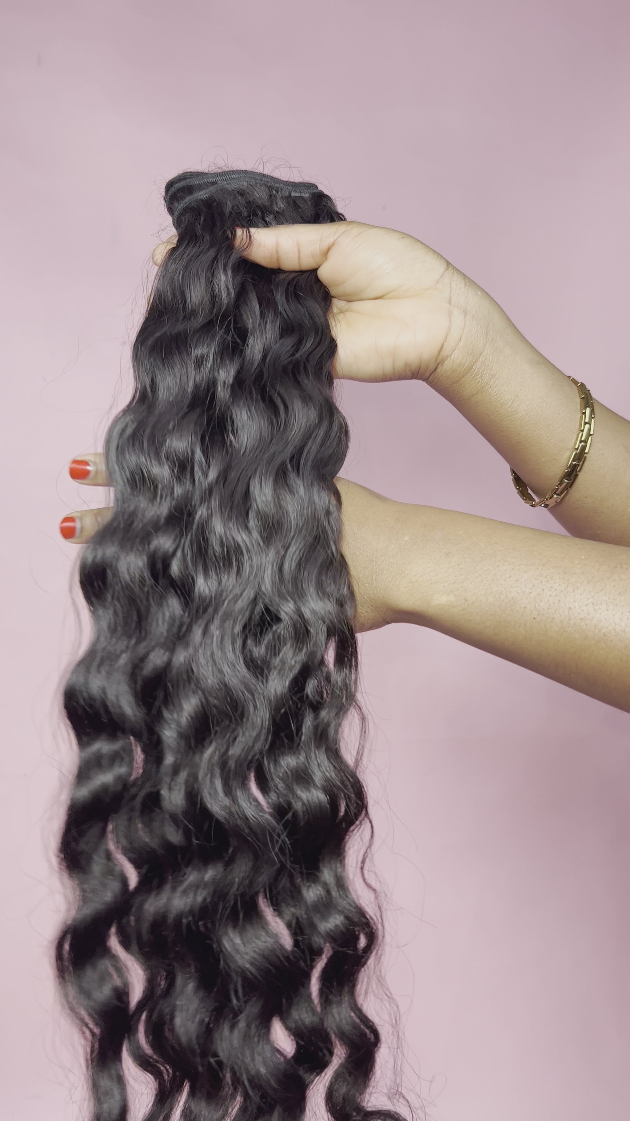 A close up video of 100% curly raw Indian hair unprocessed, unbleached, and uncolored